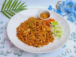 Pad Thai with thin rice noodles, dried soybean curd, ground peanuts, lime, and ground peanuts