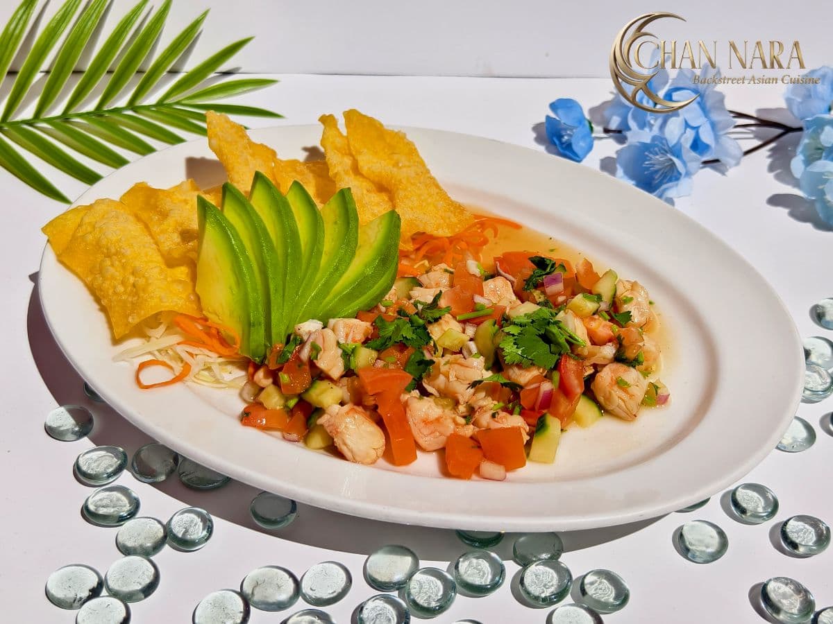 Shrimp Tom Kha Ceviche with raw shrimp, lime juice, shallots, red onion, cucumber, cilantro, rice noodle, and wonton chips