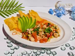 Shrimp Tom Kha Ceviche with raw shrimp, lime juice, shallots, red onion, cucumber, cilantro, rice noodle, and wonton chips