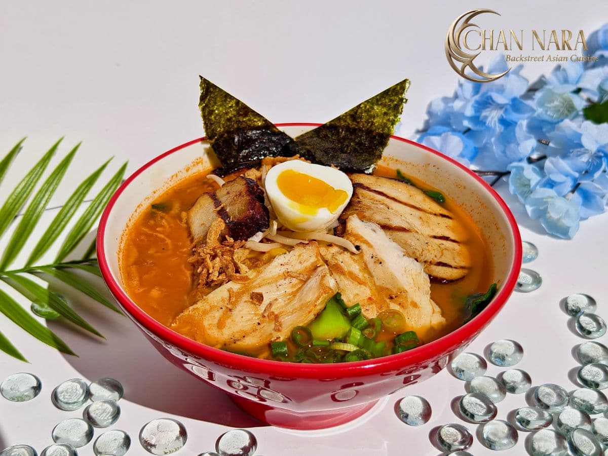 Godzilla Fire Ramen with pork chashu, grilled chicken, ground chicken, egg, bean sprout, scallions, naruto, fried onions