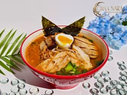Godzilla Fire Ramen with pork chashu, grilled chicken, ground chicken, egg, bean sprout, scallions, naruto, fried onions