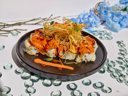 Volcano Roll with spicy crab, cream cheese, jalapeno, spicy tuna, scallop, fried potatoes, scallion, and masago