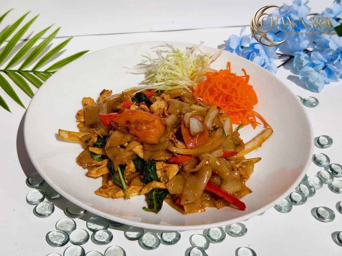Drunken spicy stir fry with wide noodles, Thai basil, onions, and bell peppers