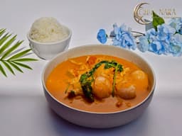 Red Curry with chili peppers, coconut milk, Thai basil, cherry tomatoes, pineapple, and lychee