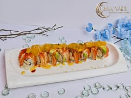Tropical Sunset Roll with real crab, crunch, avocado, mango salsa, salmon, spicy gochujang and Hawaiian sauce