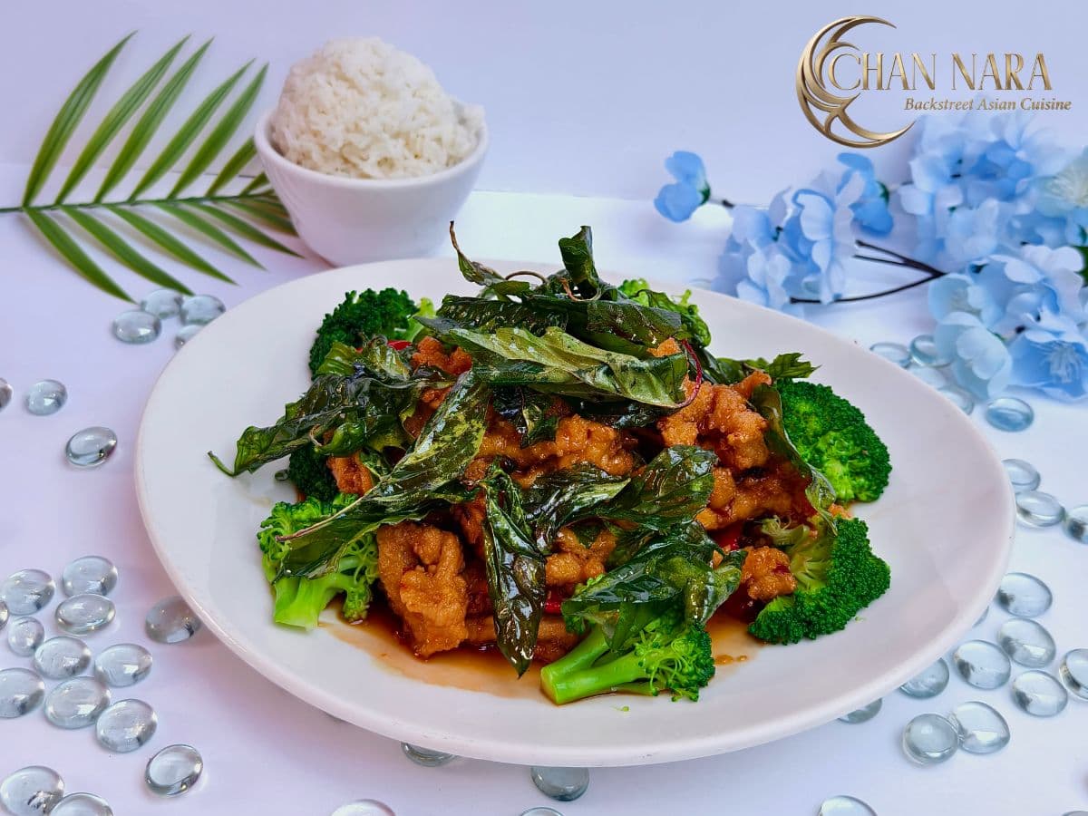 Crispy Chicken Basil with golden-brown crispy chicken, Thai basil, fresh chili, garlic, and steamed broccoli
